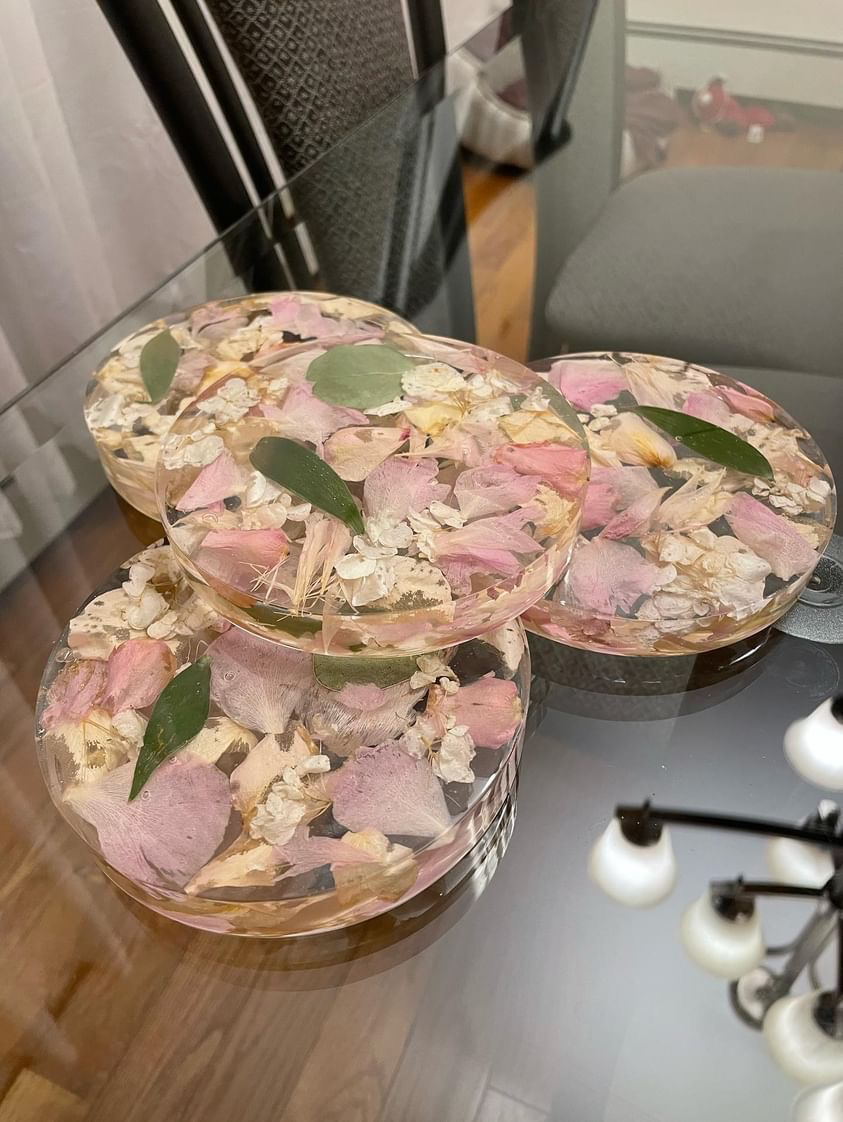 Set of Resin Floral Preservation Coasters protecting a table surface with custom wedding flowers embedded.