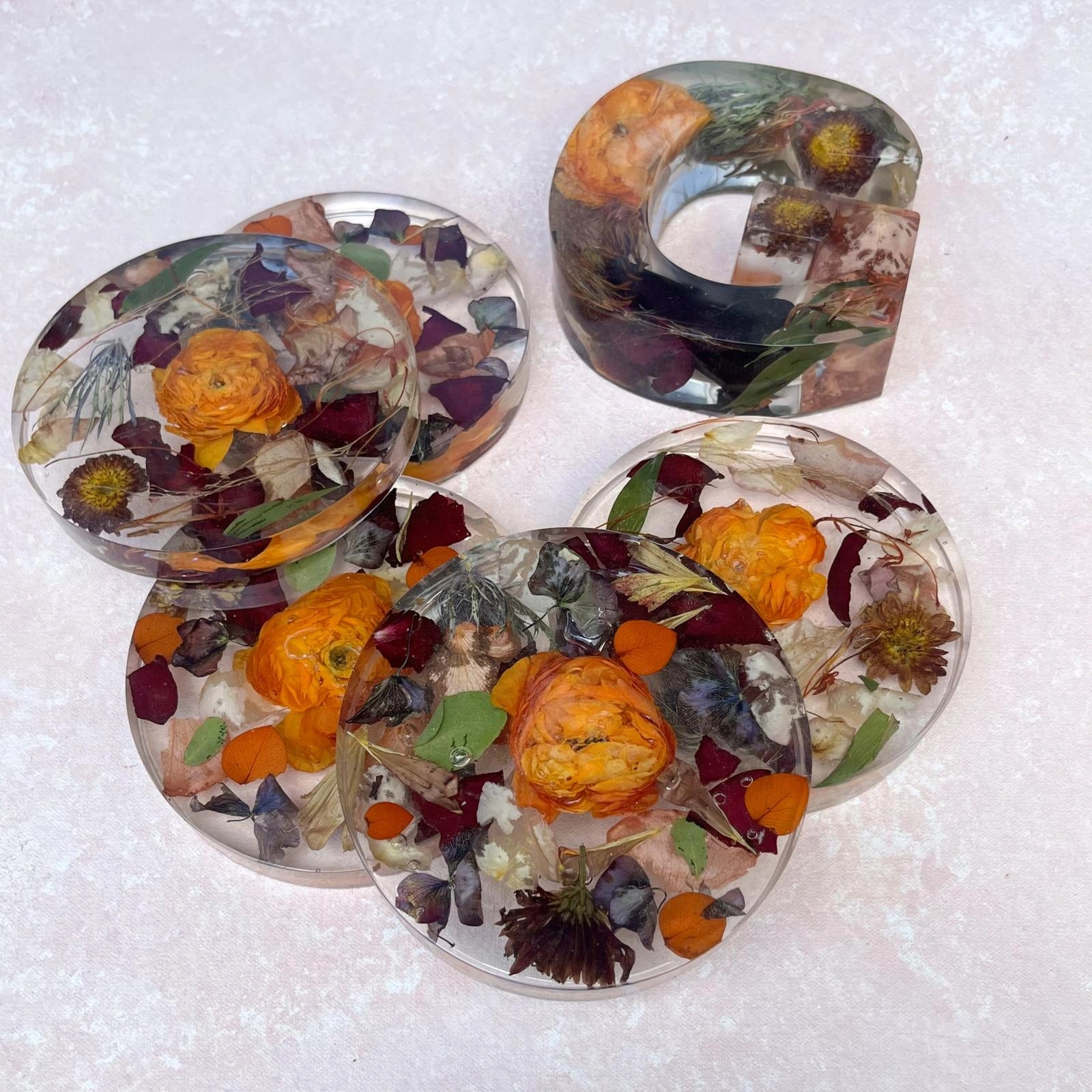 Set of Resin Floral Preservation Coasters protecting a table surface with custom wedding flowers embedded.