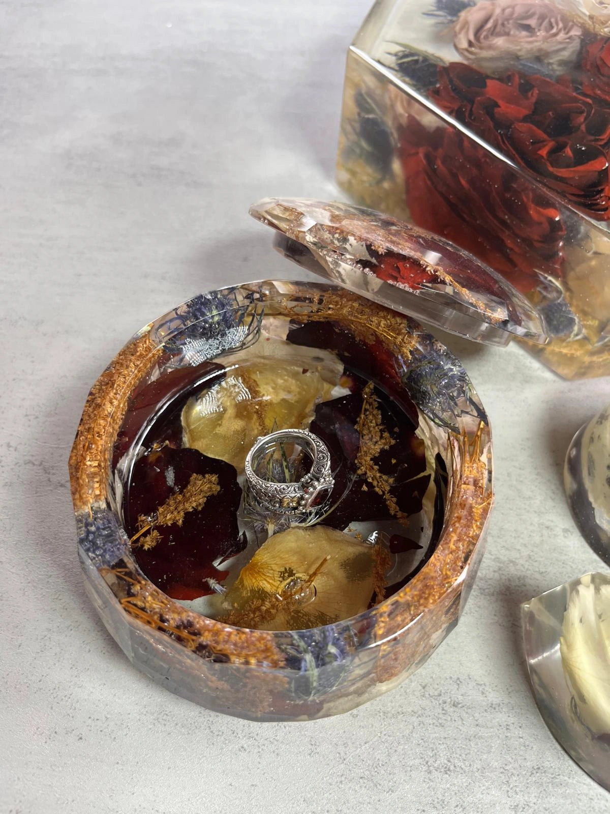 Resin Floral Preservation Jewelry Box storing wedding rings and mementos among preserved bouquet petals.