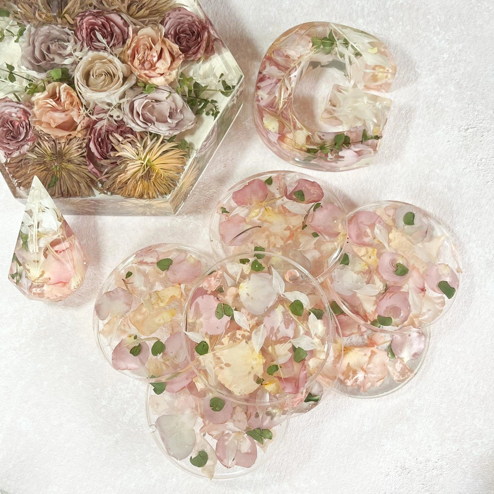 Set of Resin Floral Preservation Coasters protecting a table surface with custom wedding flowers embedded.