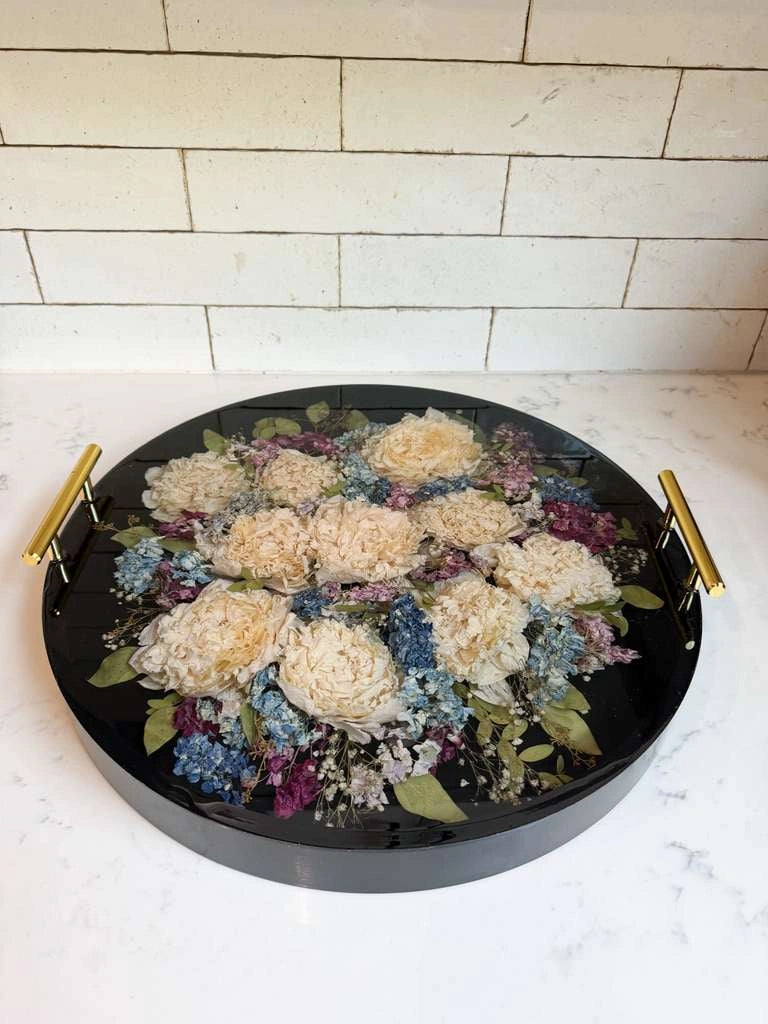 Custom round resin floral preservation tray displaying perfectly dried wedding bouquet flowers.