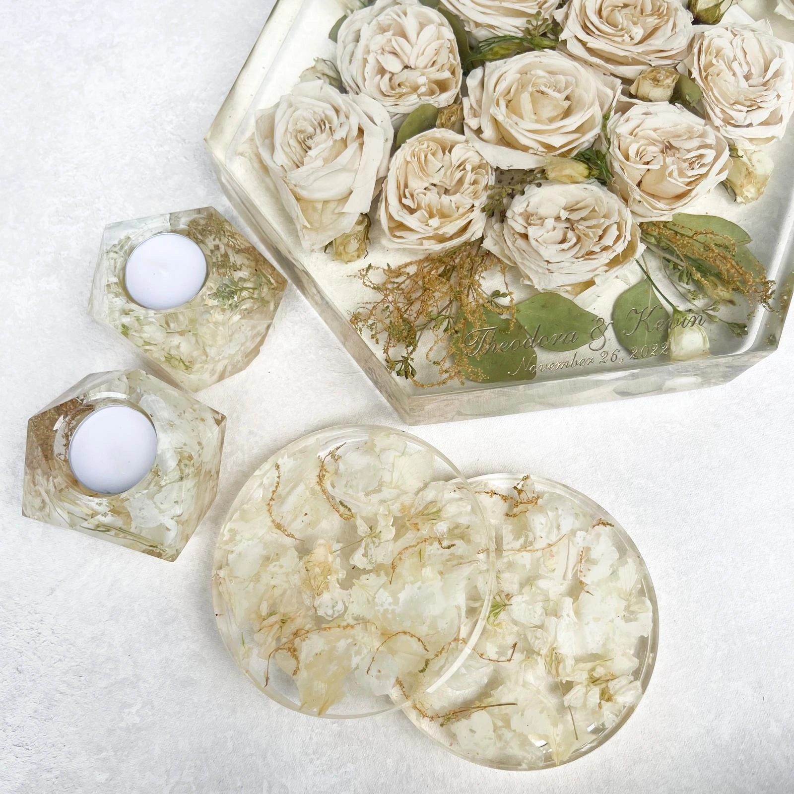 Set of Resin Floral Preservation Coasters protecting a table surface with custom wedding flowers embedded.