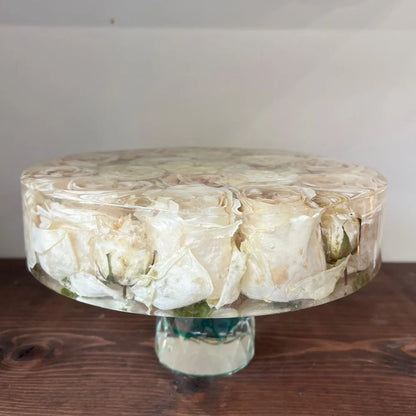 Resin Floral Preservation Cake Stand with glass dome displaying a custom preserved wedding bouquet centerpiece.