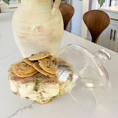 Resin Floral Preservation Cake Stand with glass dome displaying a custom preserved wedding bouquet centerpiece.