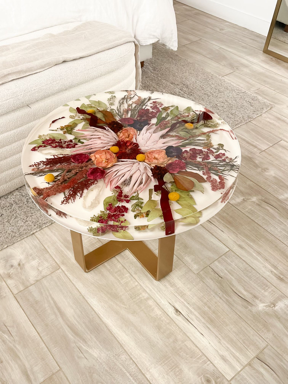 Large Resin Floral Preservation Coffee Table serving as luxury home furniture with a full preserved wedding bouquet inside.