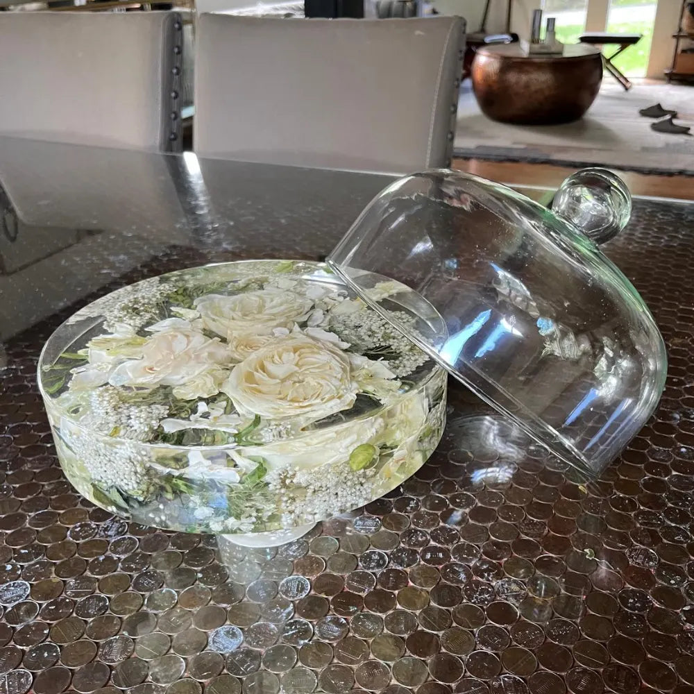 Resin Floral Preservation Cake Stand with glass dome displaying a custom preserved wedding bouquet centerpiece.