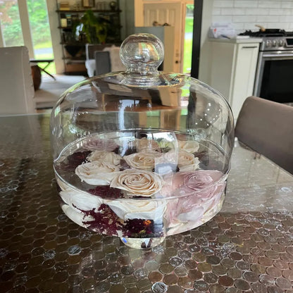 Resin Floral Preservation Cake Stand with glass dome displaying a custom preserved wedding bouquet centerpiece.