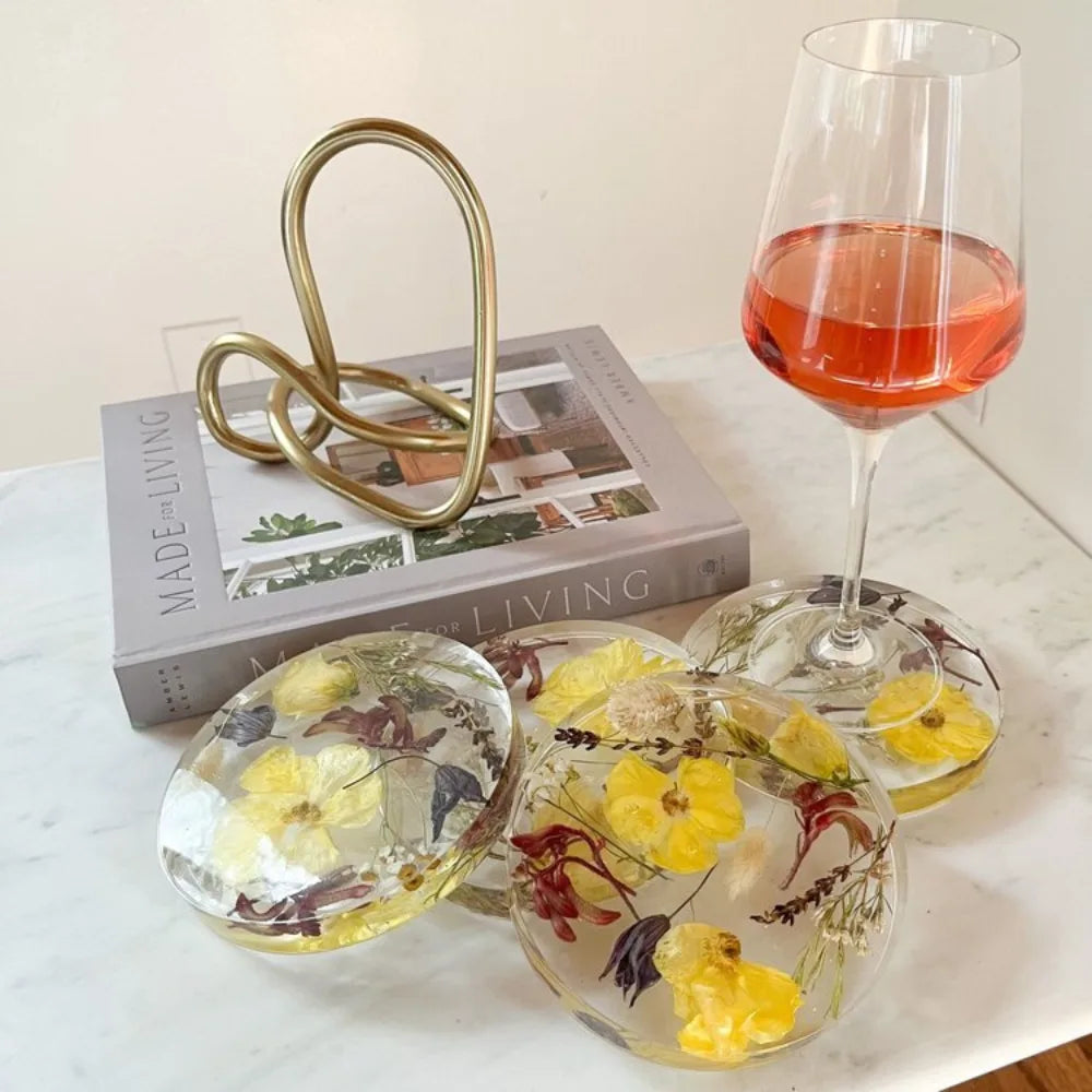 Set of Resin Floral Preservation Coasters protecting a table surface with custom wedding flowers embedded.