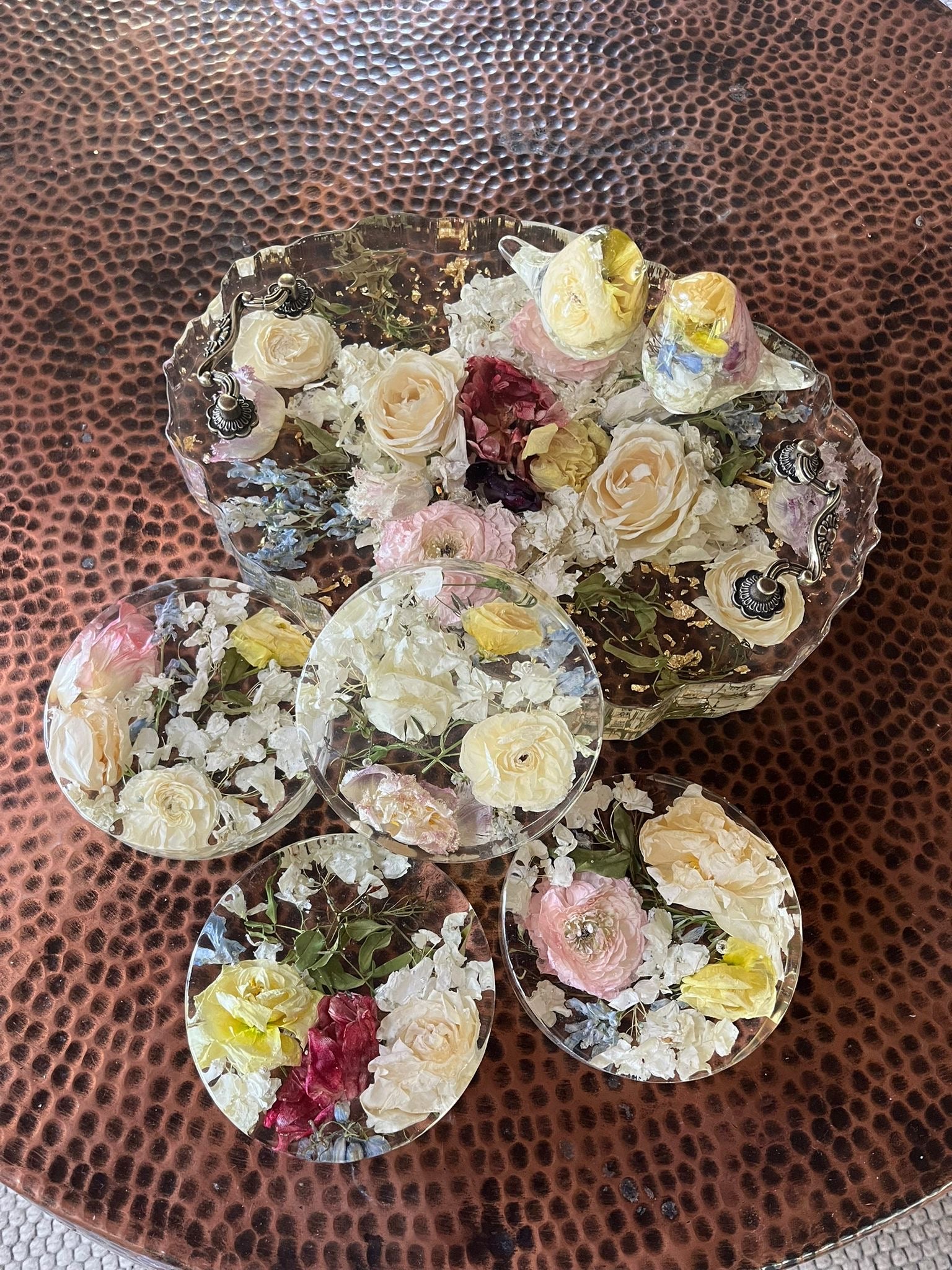 Set of Resin Floral Preservation Coasters protecting a table surface with custom wedding flowers embedded.