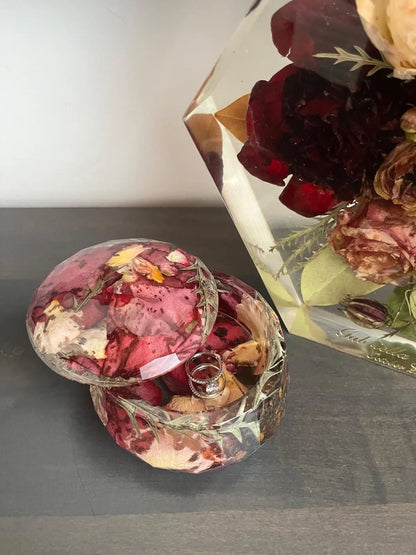 Resin Floral Preservation Jewelry Box storing wedding rings and mementos among preserved bouquet petals.
