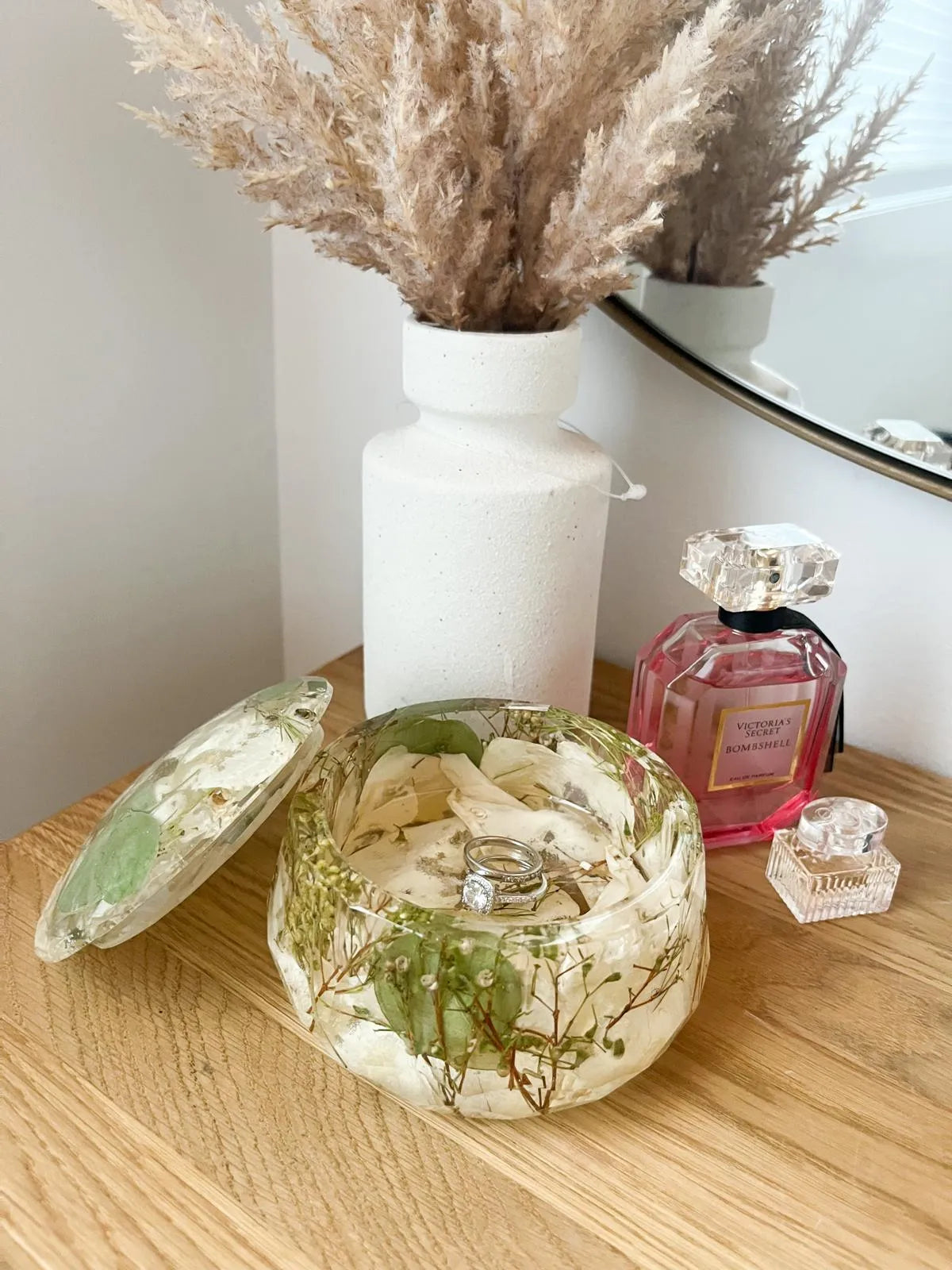 Resin Floral Preservation Jewelry Box storing wedding rings and mementos among preserved bouquet petals.