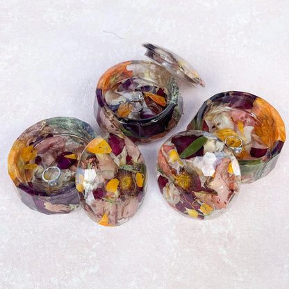 Resin Floral Preservation Jewelry Box storing wedding rings and mementos among preserved bouquet petals.