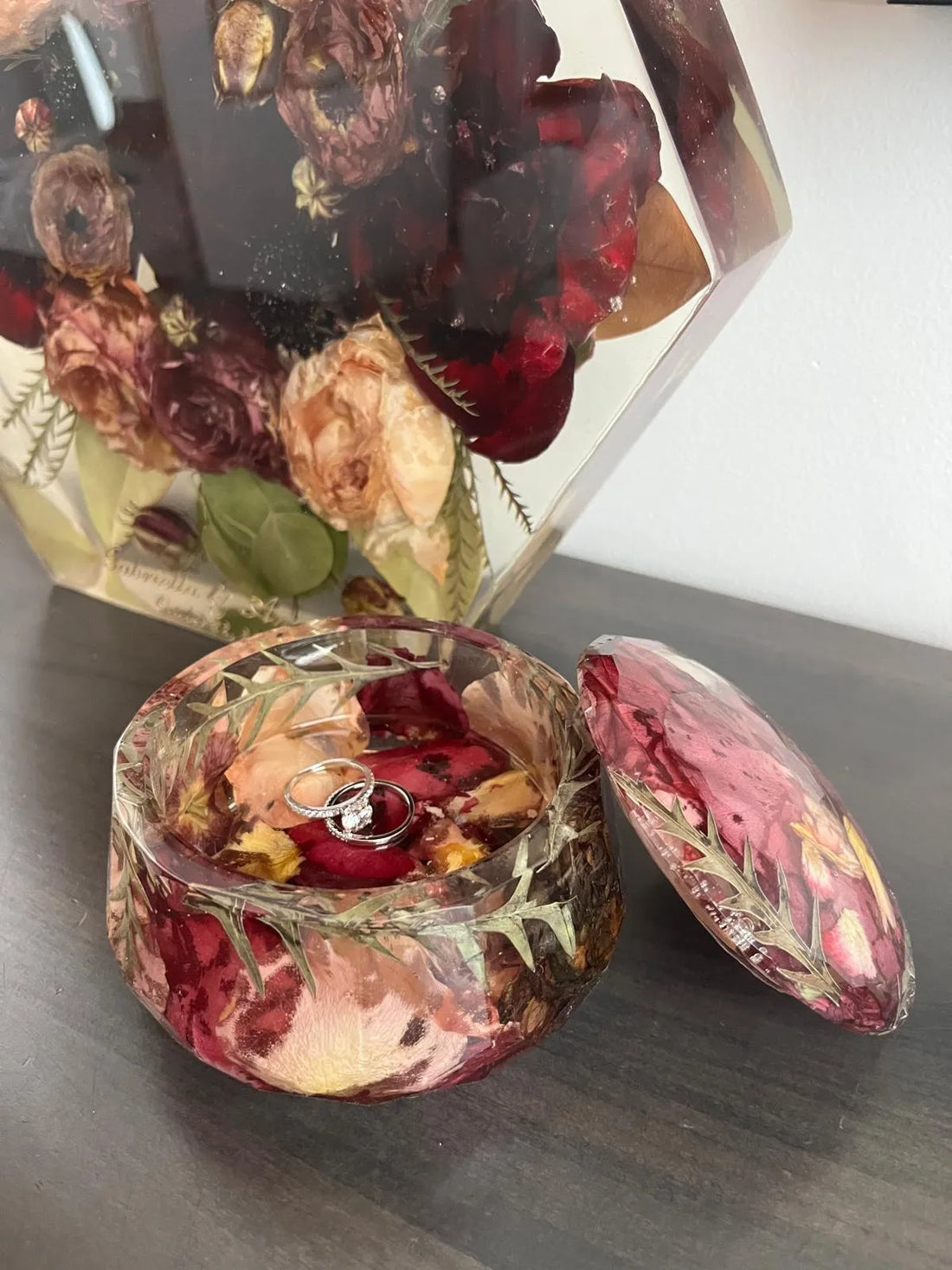Resin Floral Preservation Jewelry Box storing wedding rings and mementos among preserved bouquet petals.