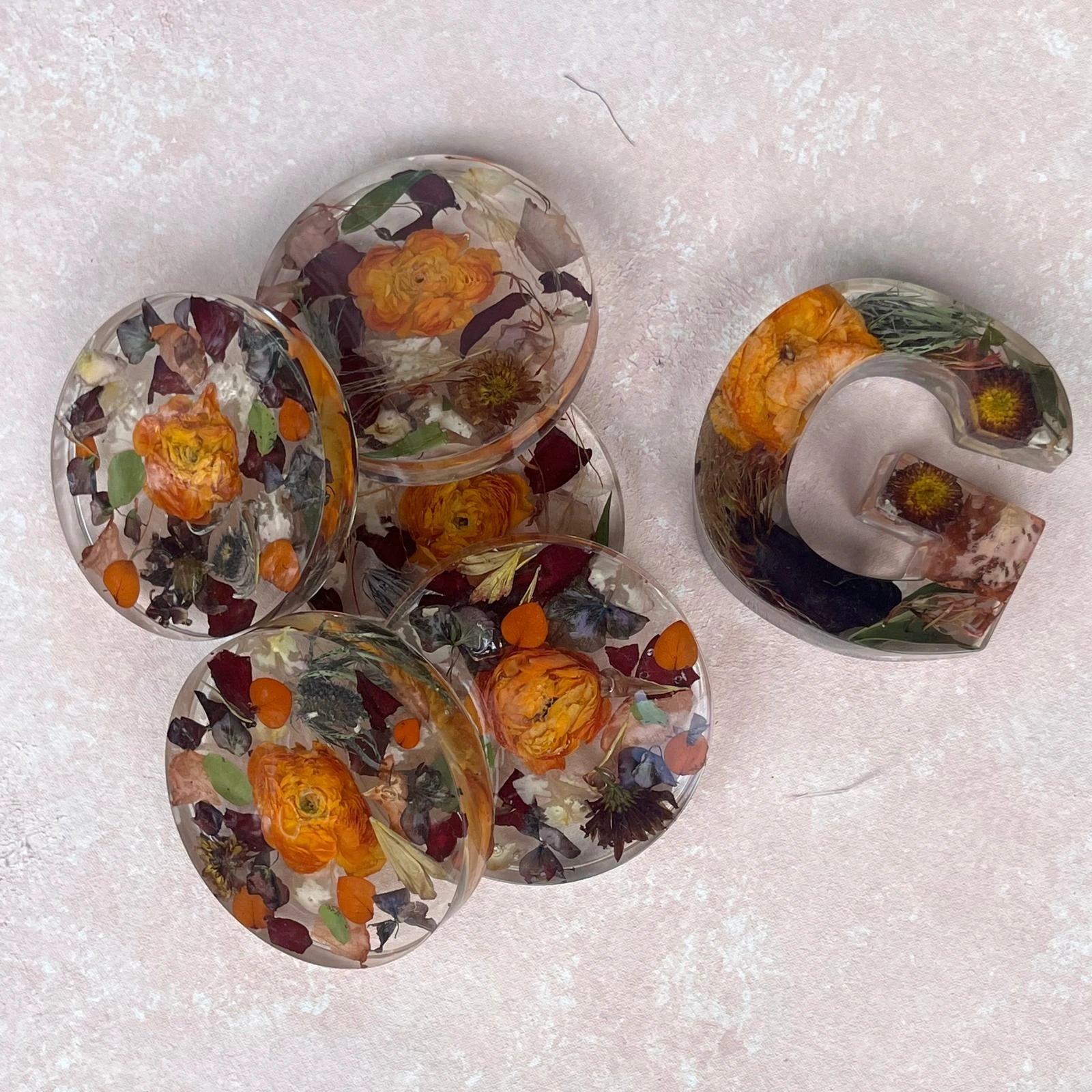Set of Resin Floral Preservation Coasters protecting a table surface with custom wedding flowers embedded.