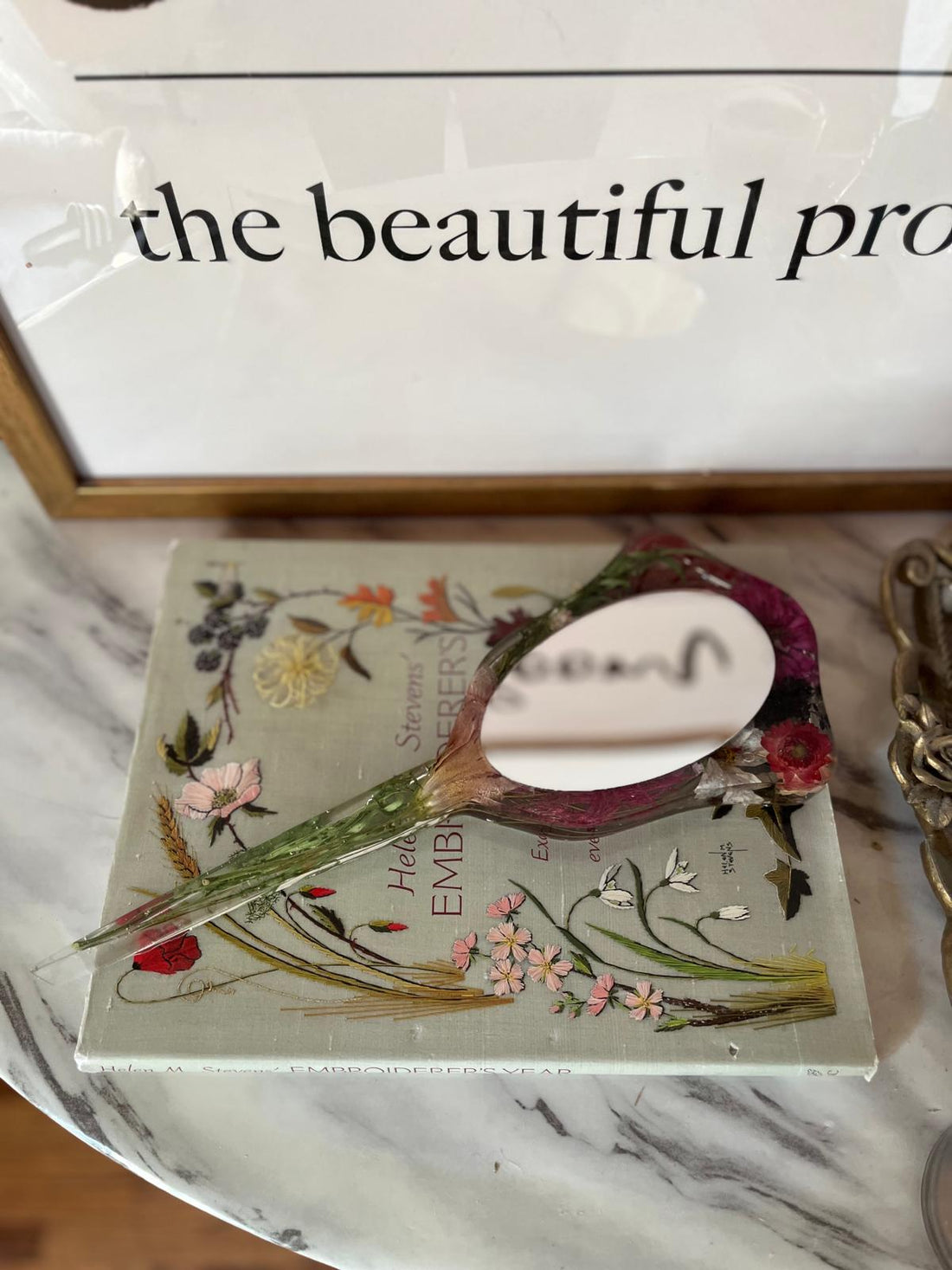 Resin Floral Preservation Hand Mirror featuring real preserved wedding petals on a bridal vanity.
