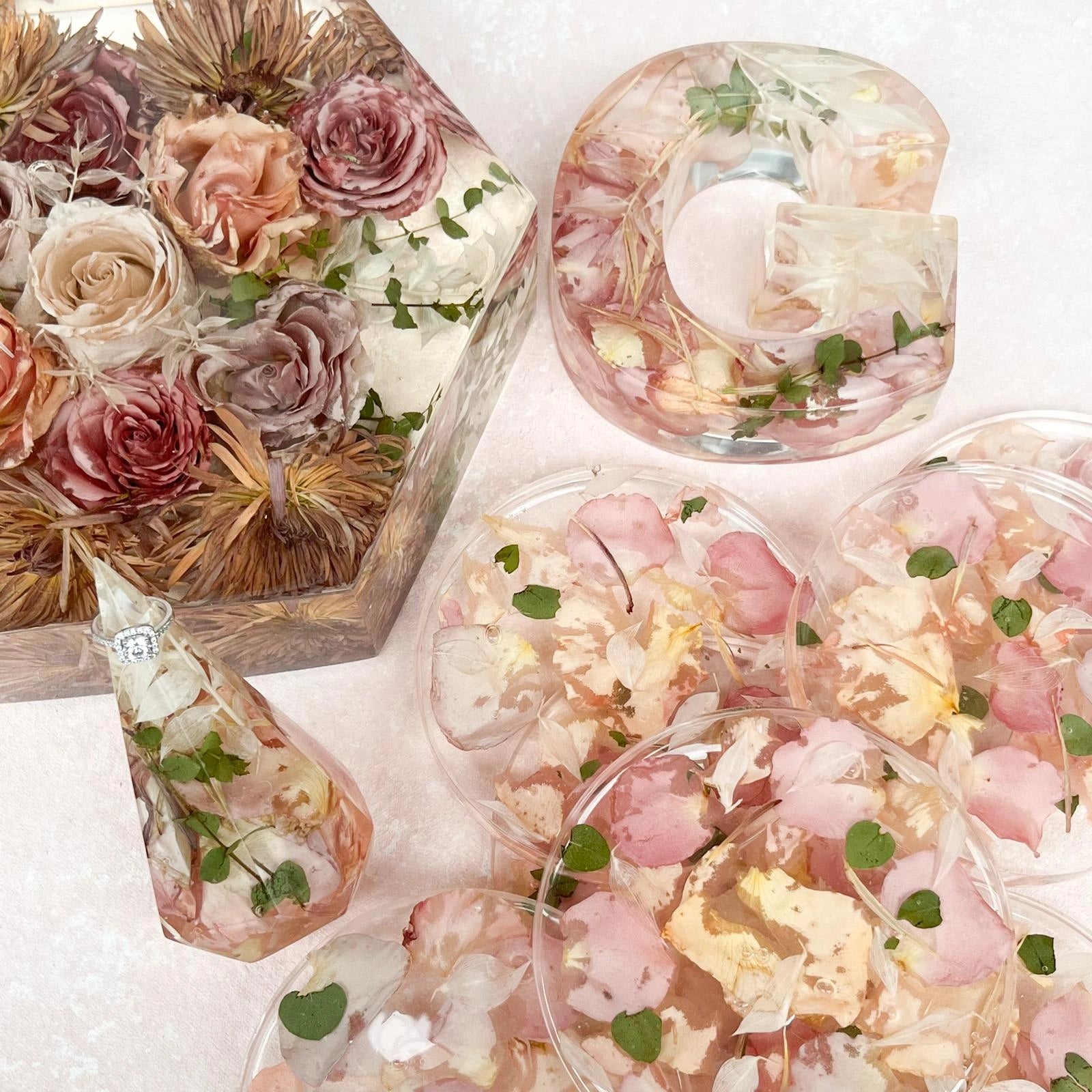 Set of Resin Floral Preservation Coasters protecting a table surface with custom wedding flowers embedded.