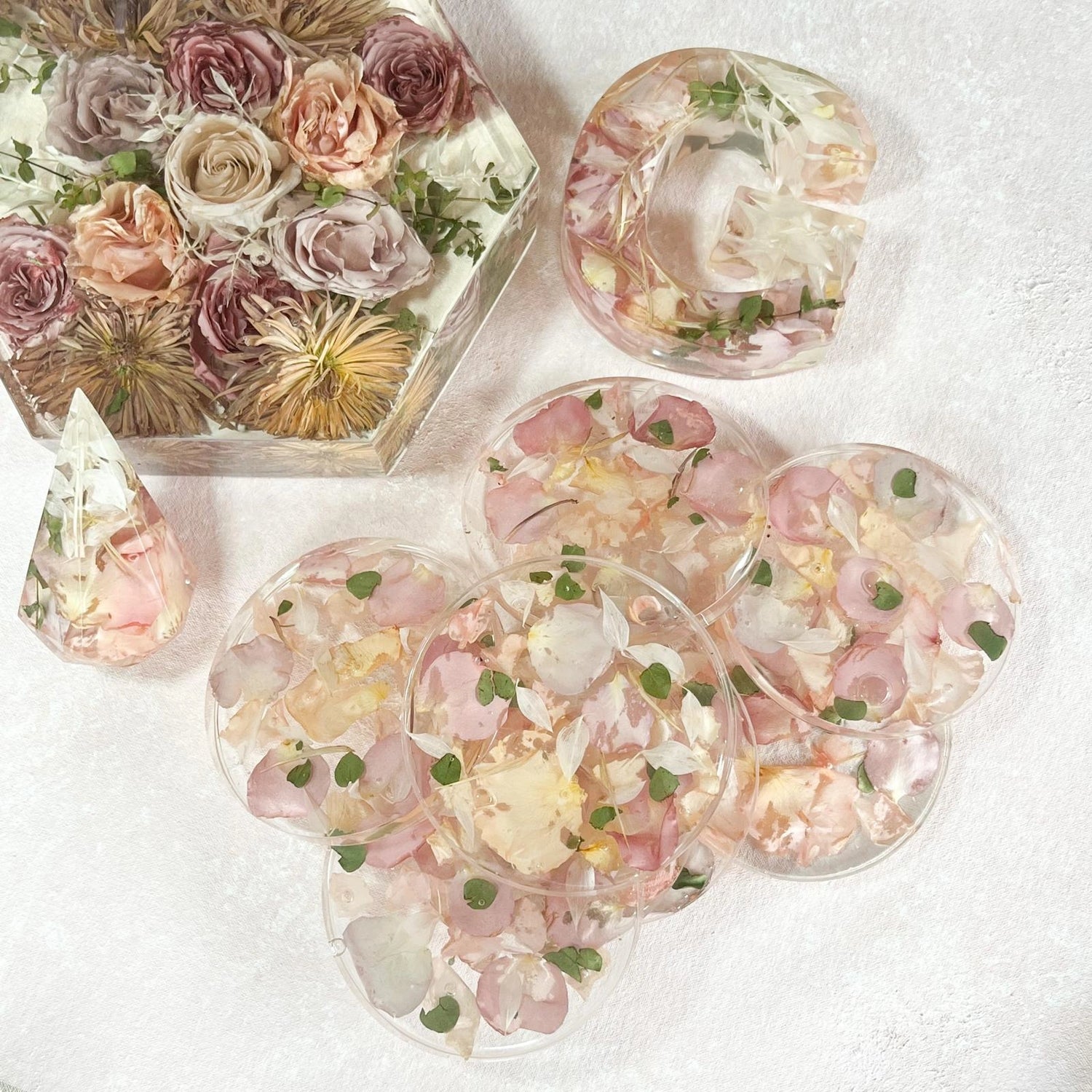 Set of Resin Floral Preservation Coasters protecting a table surface with custom wedding flowers embedded.