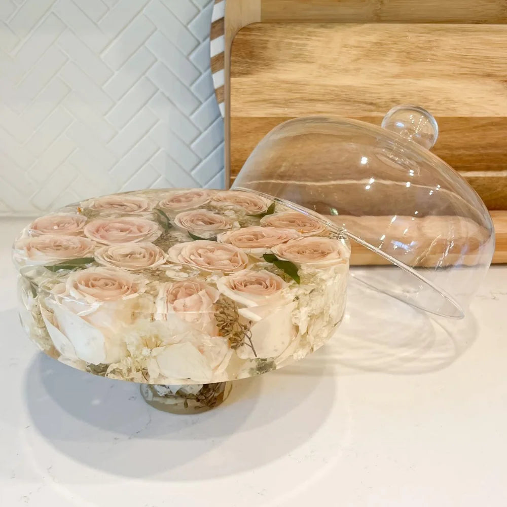 Resin Floral Preservation Cake Stand with glass dome displaying a custom preserved wedding bouquet centerpiece.