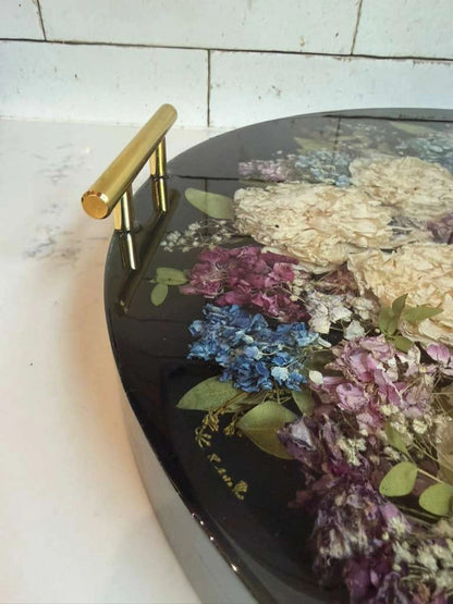 Custom round resin floral preservation tray displaying perfectly dried wedding bouquet flowers.