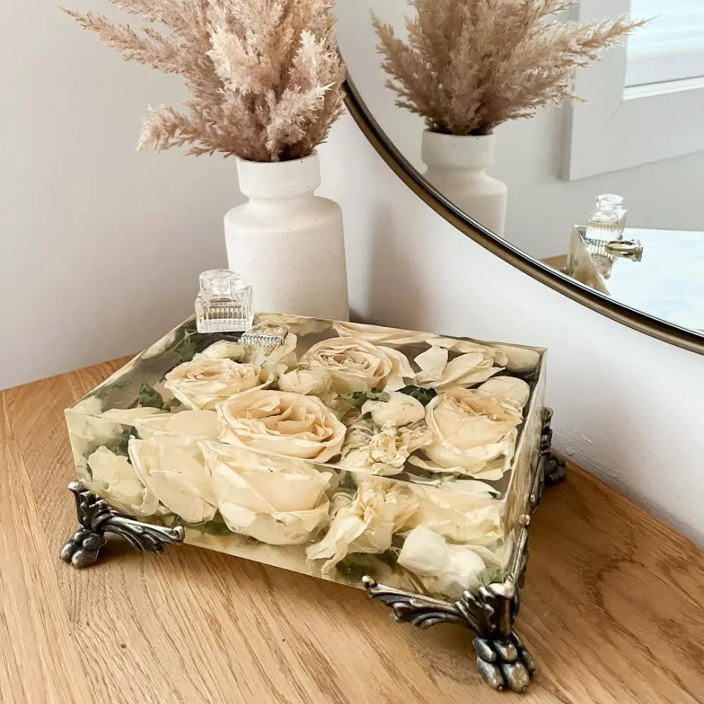 Resin Floral Preservation Vanity Tray with brass claw feet holding bridal jewelry alongside preserved wedding flowers.