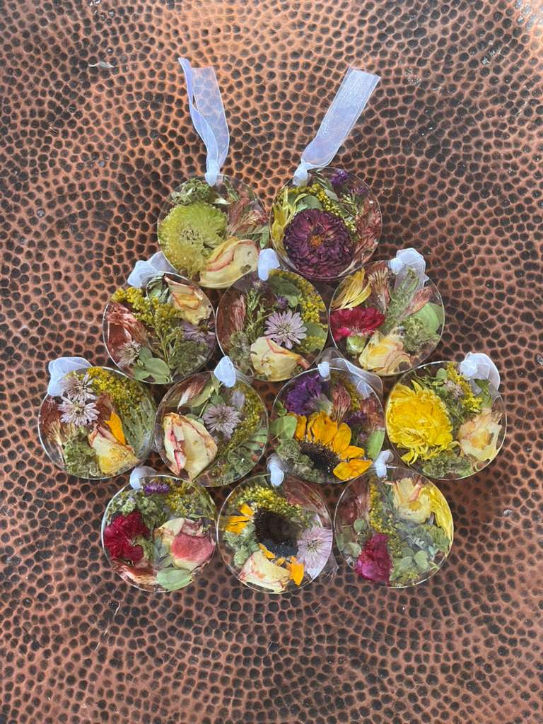 Resin Floral Preservation Ornament hanging with delicate preserved wedding bouquet petals inside.