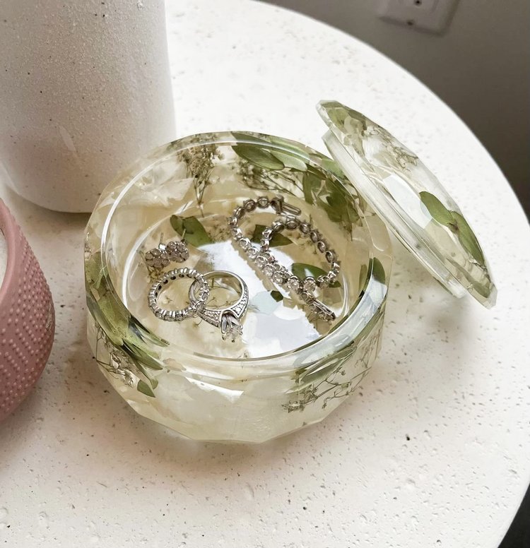 Resin Floral Preservation Jewelry Box storing wedding rings and mementos among preserved bouquet petals.